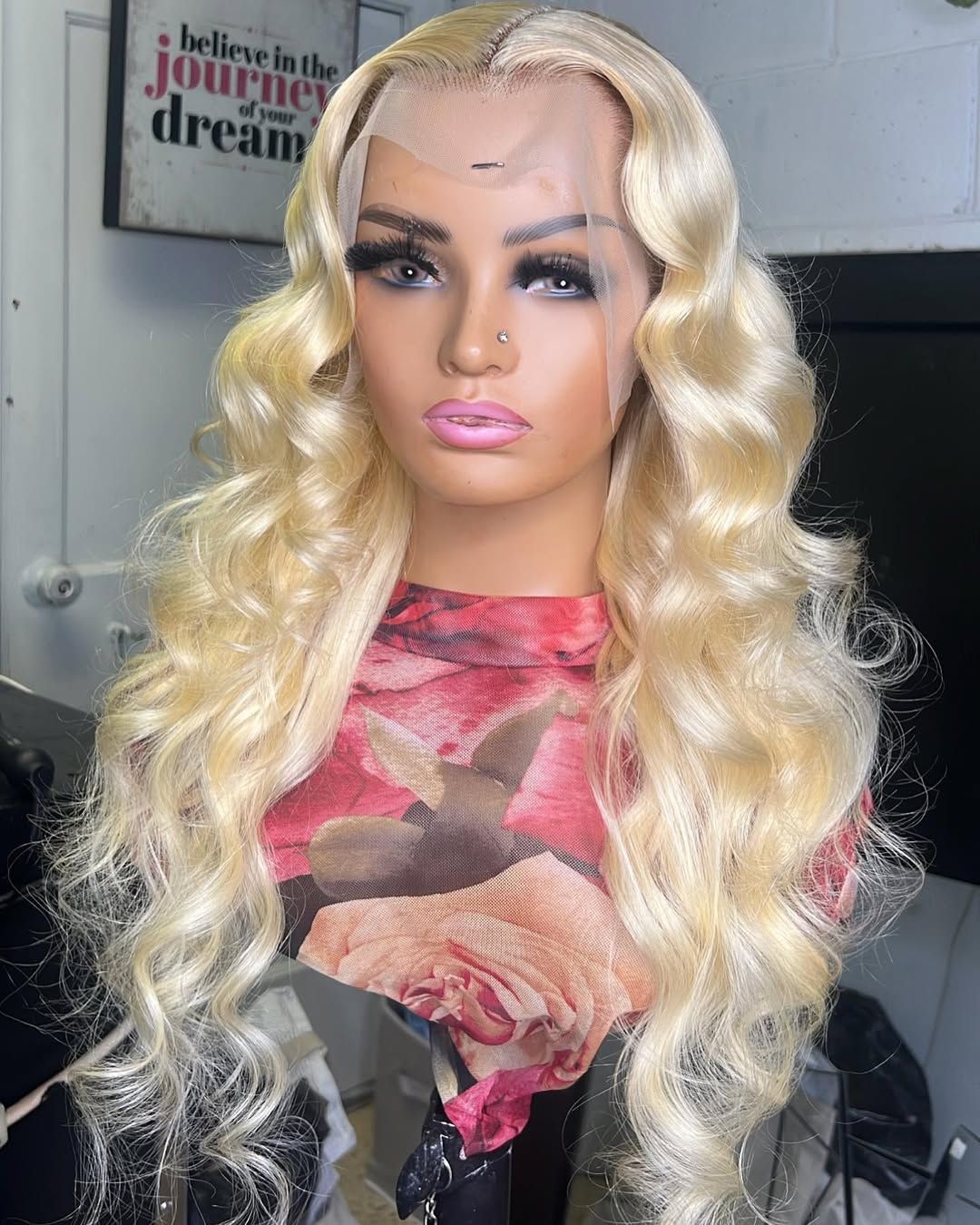 Platinum blonde loose curl wig on a mannequin